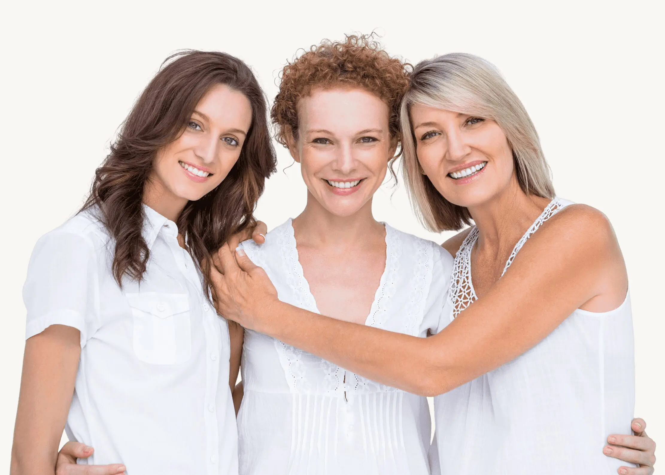Three smiling women of different ages embracing each other warmly.