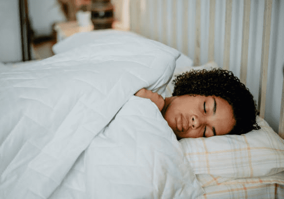 Person sleeping peacefully in bed.